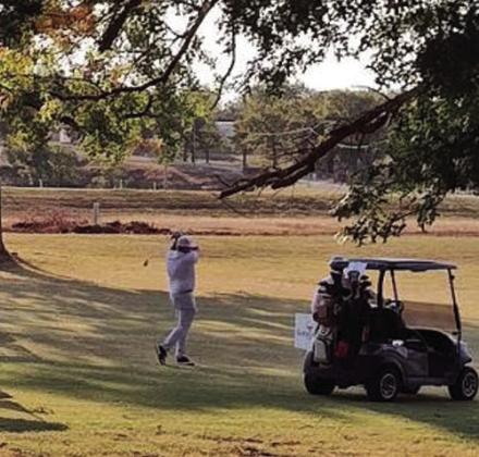 Troy Lester takes a practice swing while waiting for tournament to begin.
