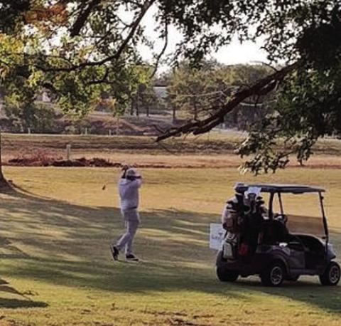 Troy Lester takes a practice swing while waiting for tournament to begin.