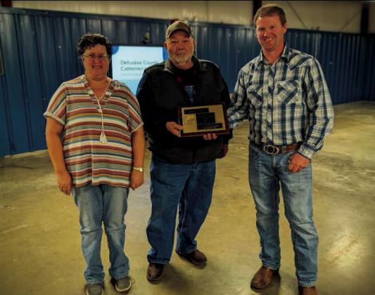 Tom and Conda Goode are presented with OCCA Farm Family of the Year plaque by OCCA President Buck Rich. courtesy photo
