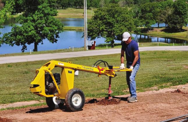 Robert Cervantez, of Champion Fence, drills a fencing post hole. courtesy photo