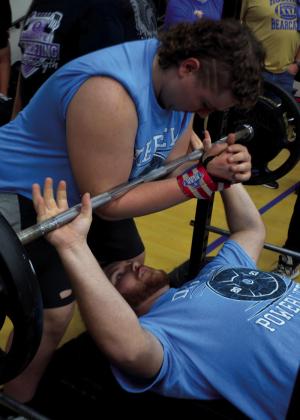 Seth McDaniel spotted by Christopher White practicing the bench press.