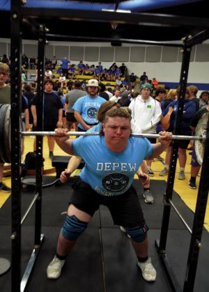 Christopher White doing a squat.