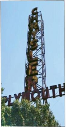 By 2018, tree growth had nearly engulfed the lower section of the deteriorated Chrysler Tower in its original location in Bristow, Oklahoma. courtesy photo