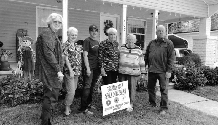 The Bristow Garden Club chose the yard of Linda Wahl, 508 East 7th Street, as Yard of the Month for October. From left, Virginia Ray, Carolyn Kuykendall, Marla Wahl, Ruth Jaytaine, Norma Carmen, and David Ray. courtesy photo