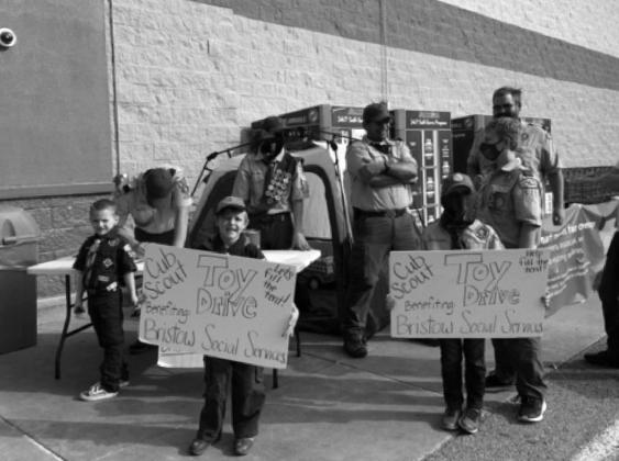 Pictured above and below, Scouts from Pack 571 collecting donations for the community service toy drive. courtesy photo
