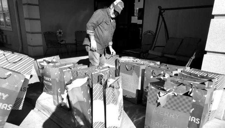 Ted Smith gets presents ready to give to the Rainbow Nursing Home community to help make their holiday special. courtesy photo