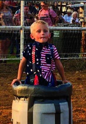Turner Tacket, age 3, of Mannford brought his own protective barrell to safely watch the mutton busting. courtesy photo