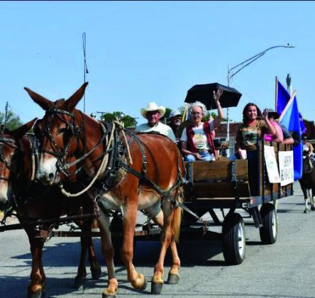 Angie Gentry photo Mayor Kris Wyatt, waves to the crowd as she rides in this mule drawn wagon.