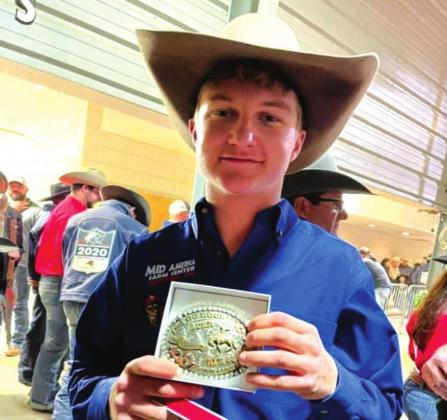 Ty Ralston shows the buckles he won. In addition to the buckles, Ty won a new customized saddle. courtesy photo