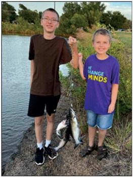 Logan and Landry with their catch from a recent fishing trip with their grandpa, Larry, at Boomer Lake . courtesy photo