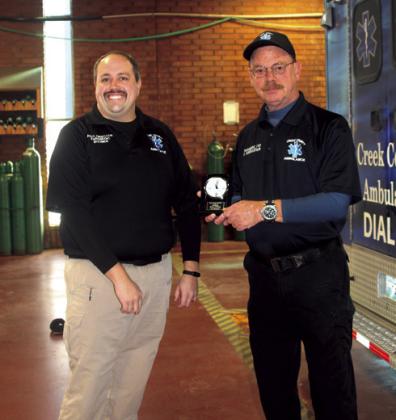 Thomas Riter, Assistant Director presents Scott Forrester with a special clock marking 25 years of service. Angie Gentry photo